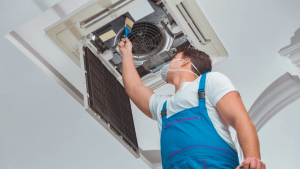 A technician cleaning and inspecting air ducts